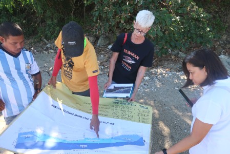 A person pointing out a location on a map