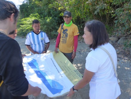 A group of people holding an area map
