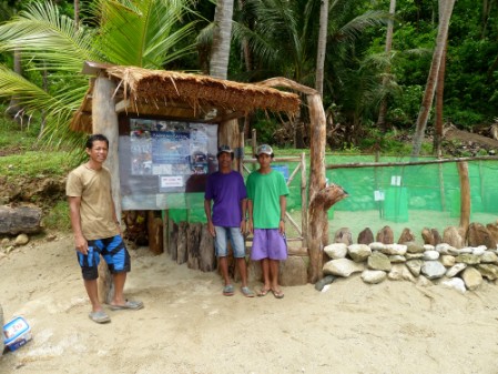 Three gathered in front of the information wall